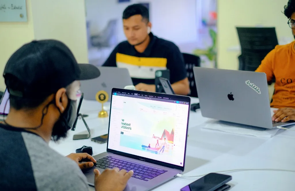 Designer working on UI/UX layouts in Figma during a team design session